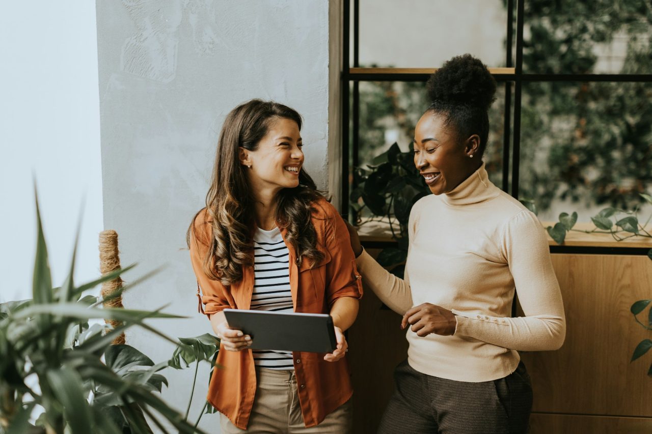 two-young-business-women-with-digital-tablet-standing-in-the-modern-office.jpg